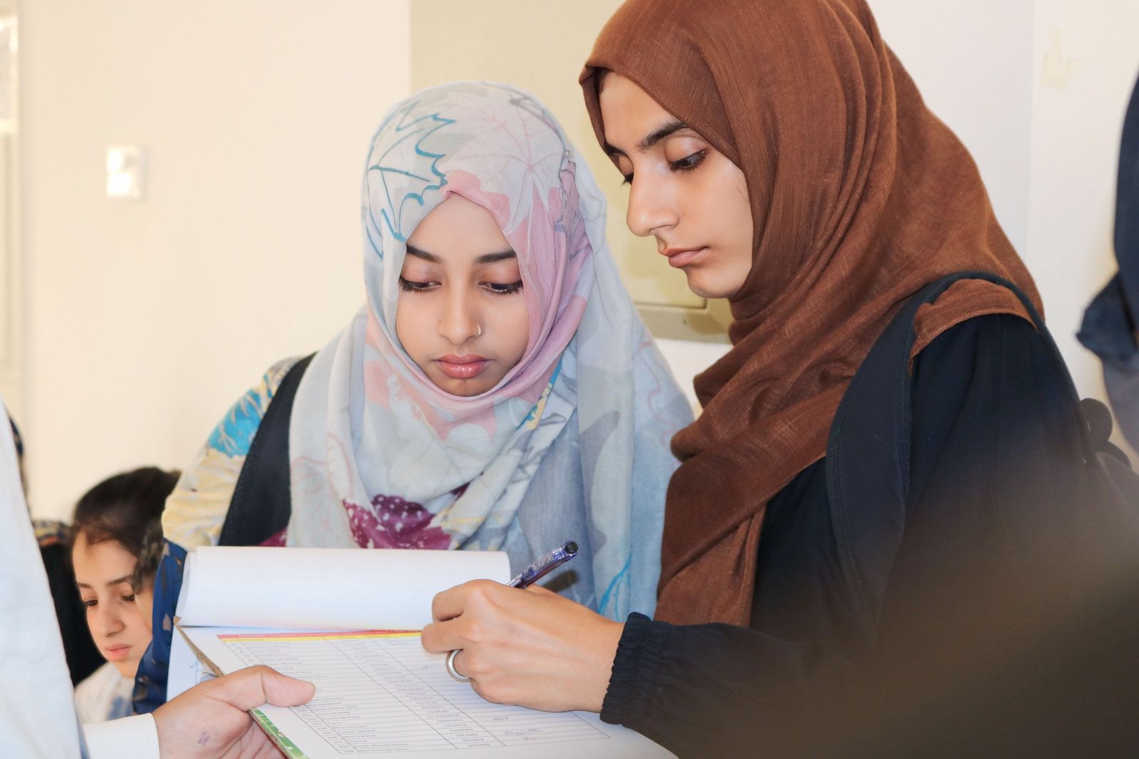 Girl students filling up a registration form